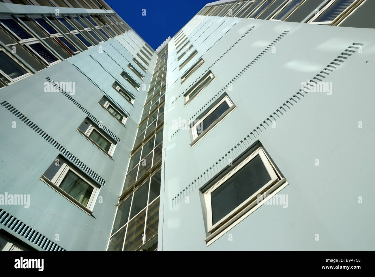 A 1960`s block of flats viewed upwards with a corner of  blue sky above Stock Photo